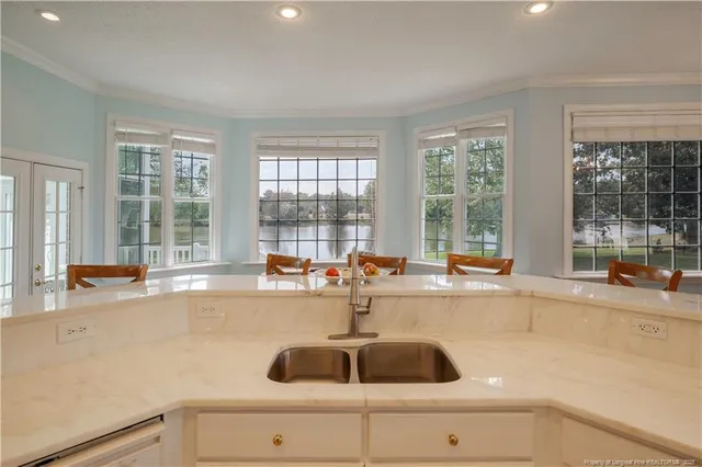 a kitchen with a sink and large window