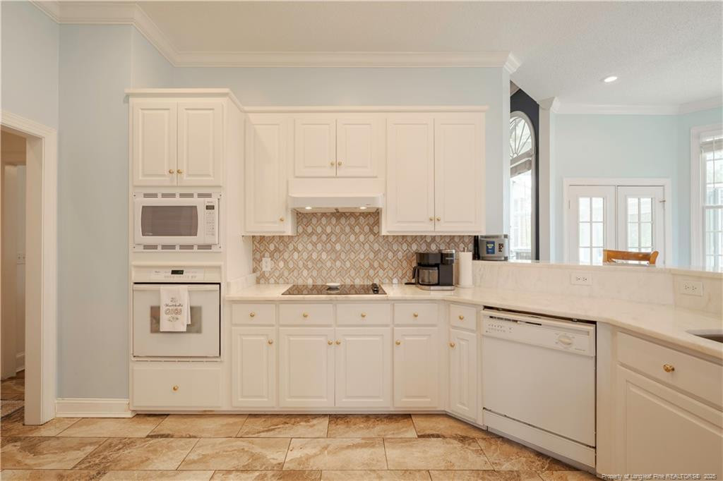 515 Briarwood Road Warsaw, NC 28398 - Photo 4 of 36 a kitchen with white cabinets and white appliances