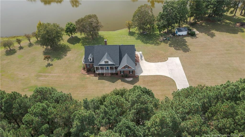 515 Briarwood Road Warsaw, NC 28398 - Photo 7 of 36 an aerial view of a house with a yard and lake view