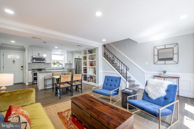 a living room with furniture kitchen view and a dining table