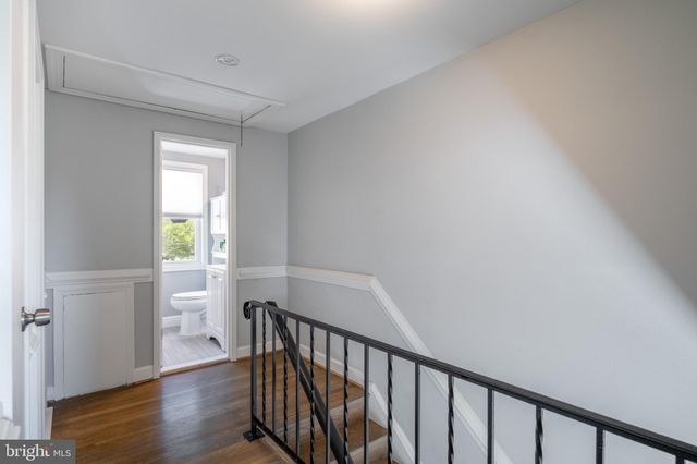 a view of hallway with wooden floor