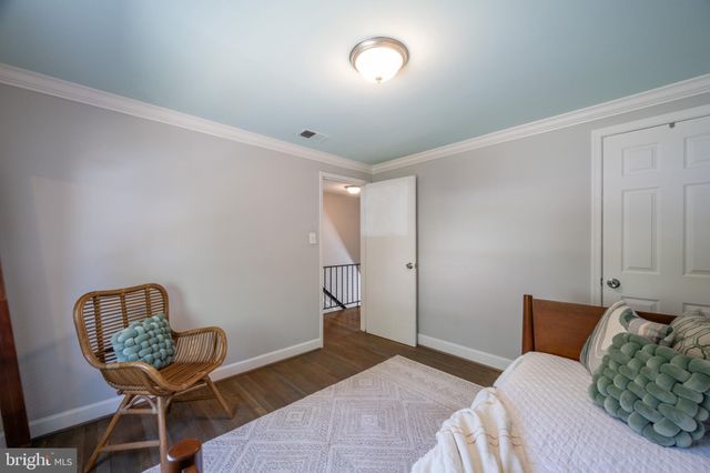 a bedroom with a bed and chair