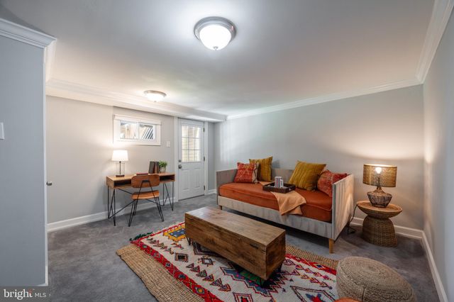 a living room with furniture a rug and a window