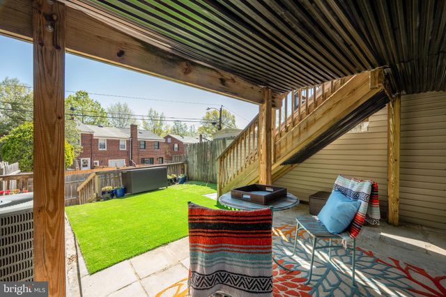 a view of a chairs and table in the backyard