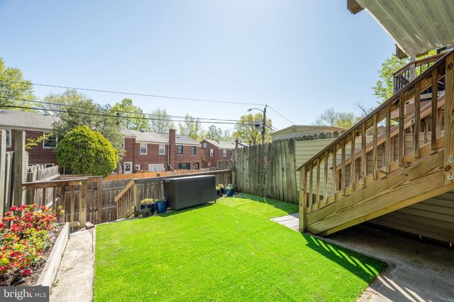 a view of a backyard with sitting area