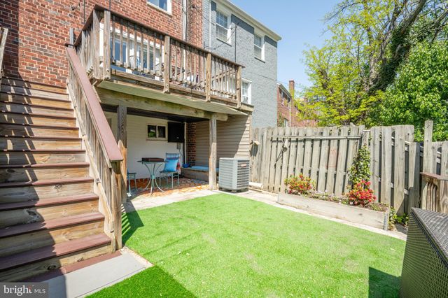 a view of a house with a yard and stairs