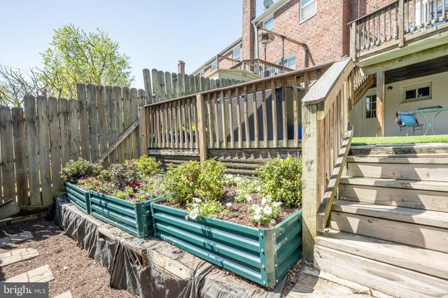 a view of a pathway of a house with a small yard