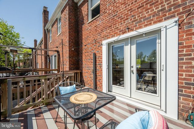 a view of a patio with table and chairs and wooden floor