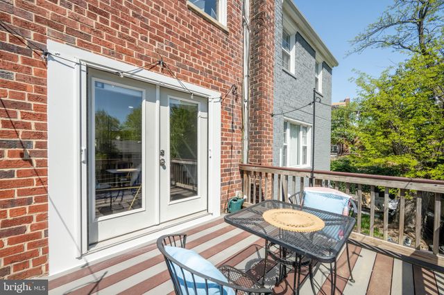a view of a chair and table in the balcony