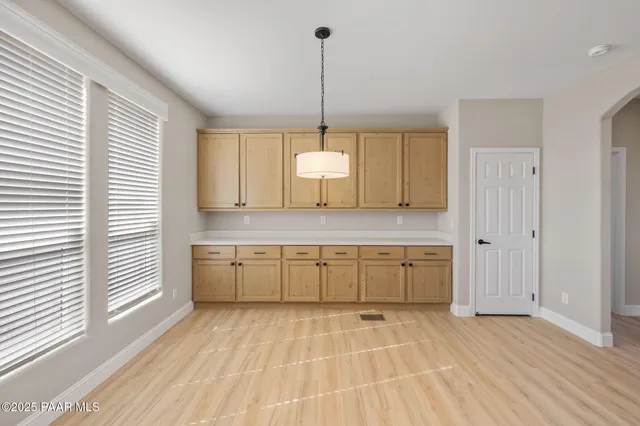 a kitchen with a sink cabinets and window