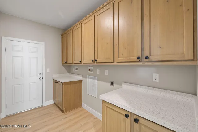 a room with wooden cabinets and sink