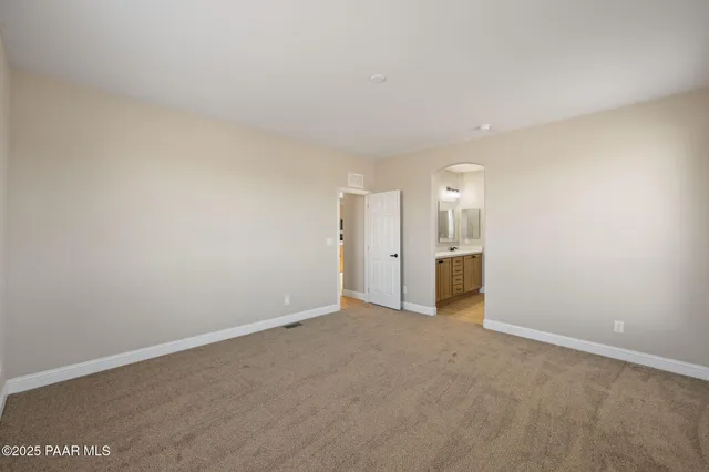 a view of an empty room with a bathroom