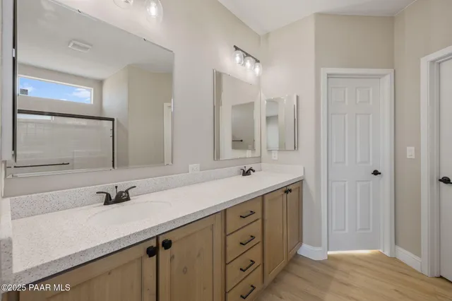 a bathroom with a sink double vanity and a mirror