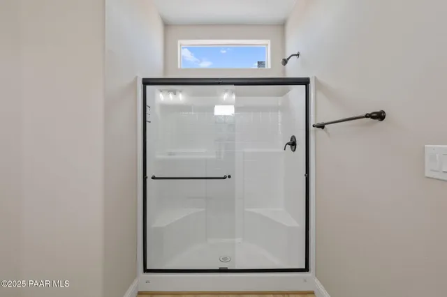a bathroom with a glass shower door