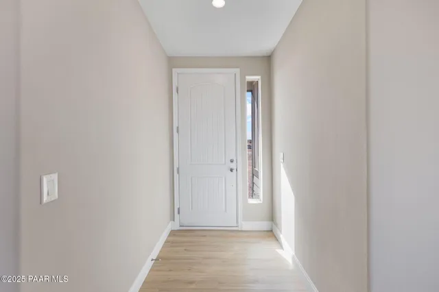 a view of a hallway with wooden floor