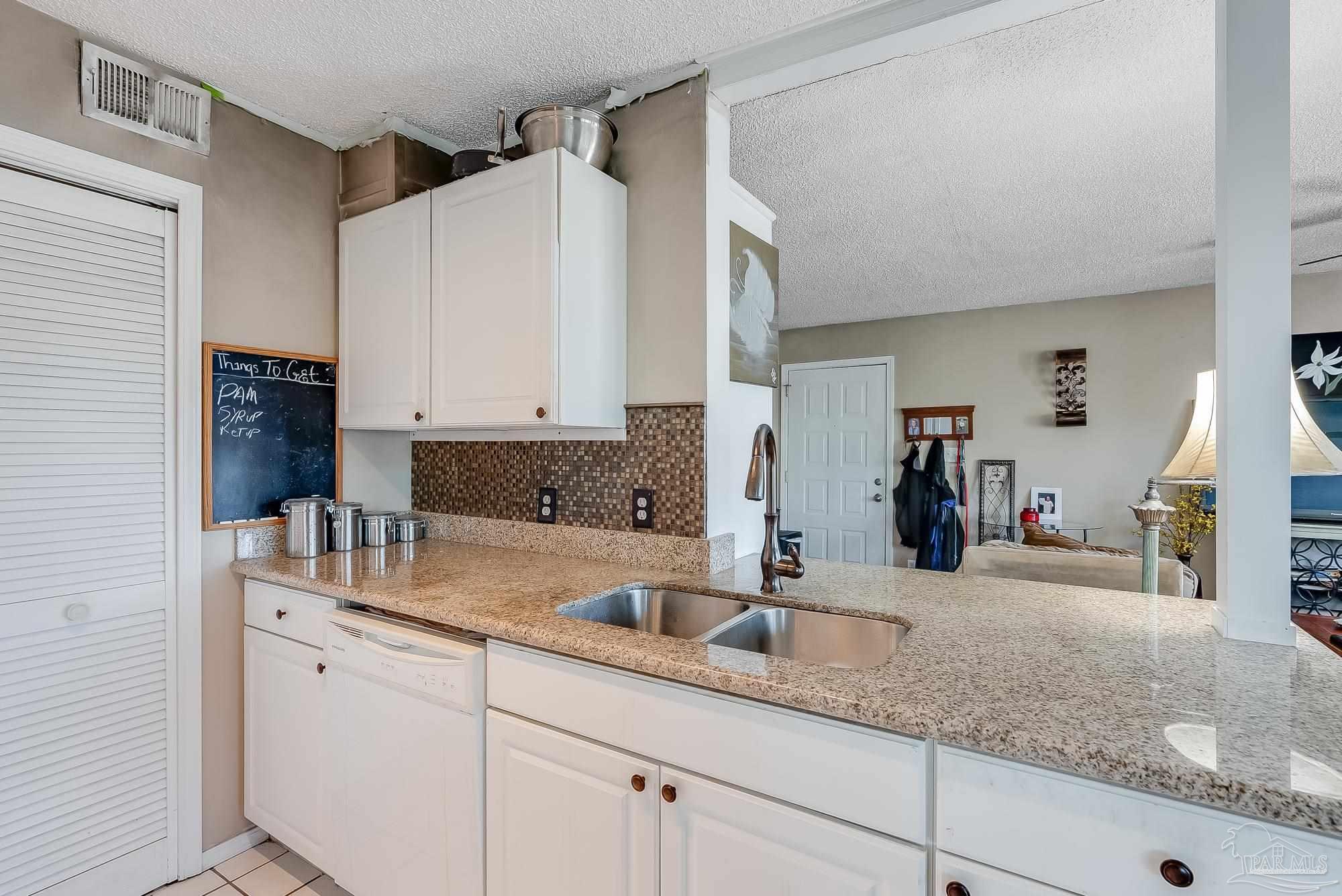 200 Pensacola Beach Road, Unit D2 Gulf Breeze, FL 32561 - Photo 15 of 40 a kitchen with sink and cabinets