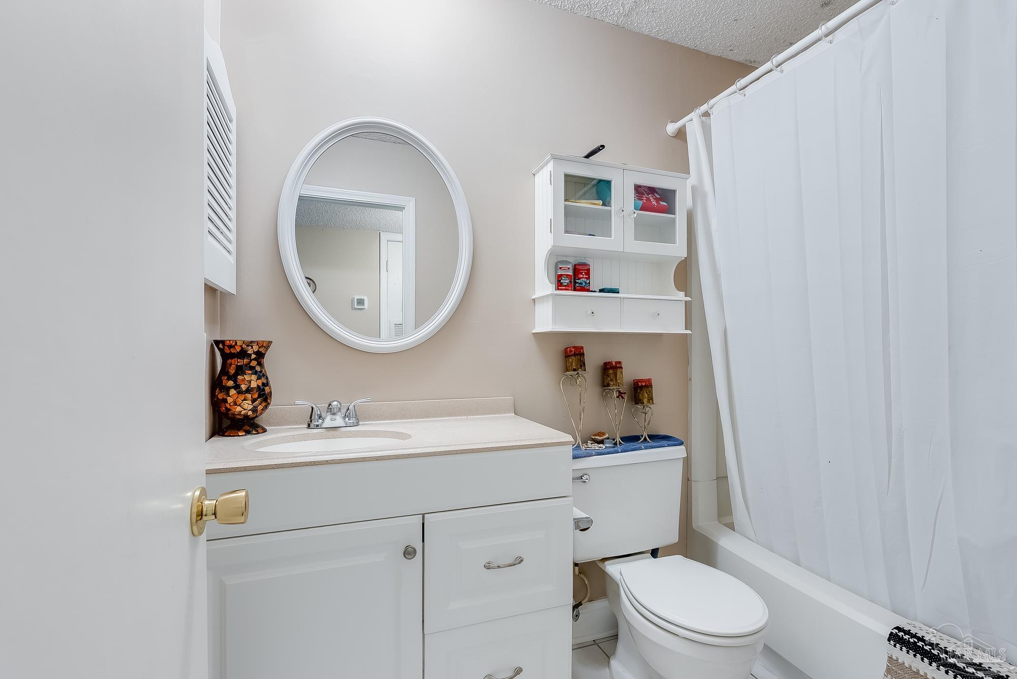 200 Pensacola Beach Road, Unit D2 Gulf Breeze, FL 32561 - Photo 21 of 40 a bathroom with a sink a toilet and a mirror