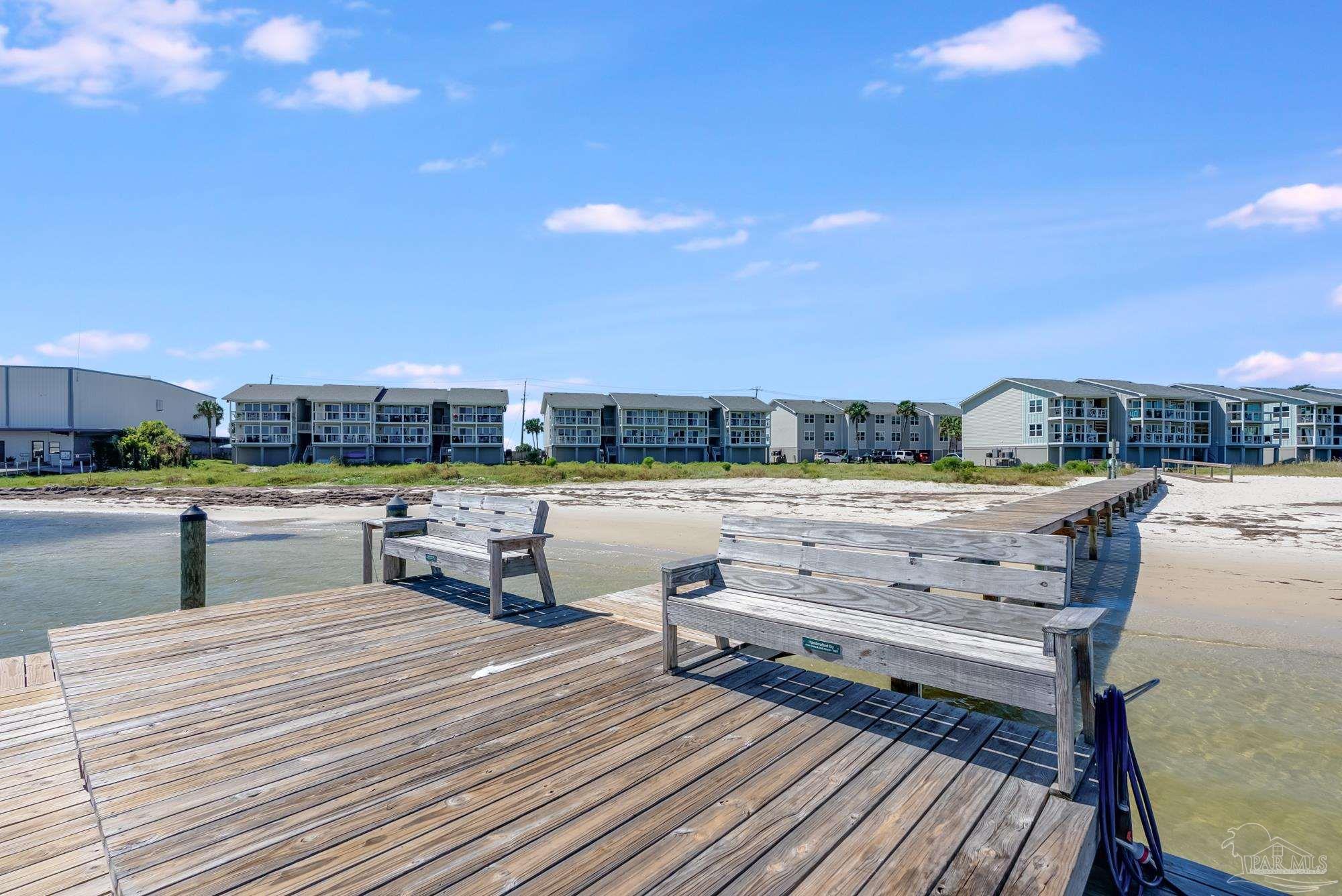 200 Pensacola Beach Road, Unit D2 Gulf Breeze, FL 32561 - Photo 27 of 40 a view of a swimming pool with outdoor seating and yard in the back