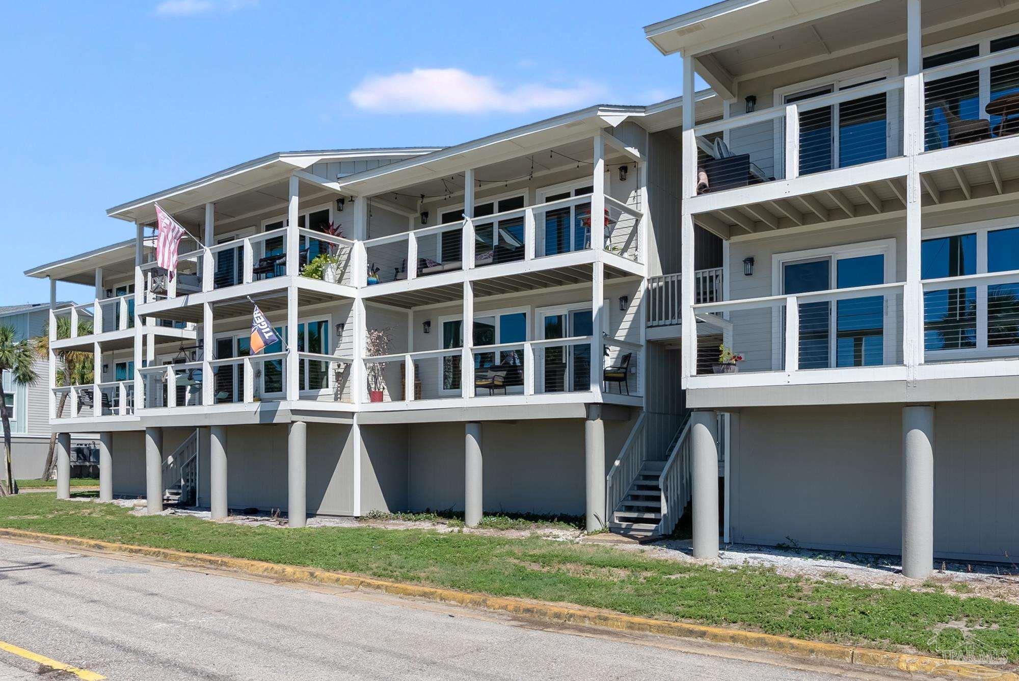 200 Pensacola Beach Road, Unit D2 Gulf Breeze, FL 32561 - Photo 4 of 40 a front view of a building with a yard