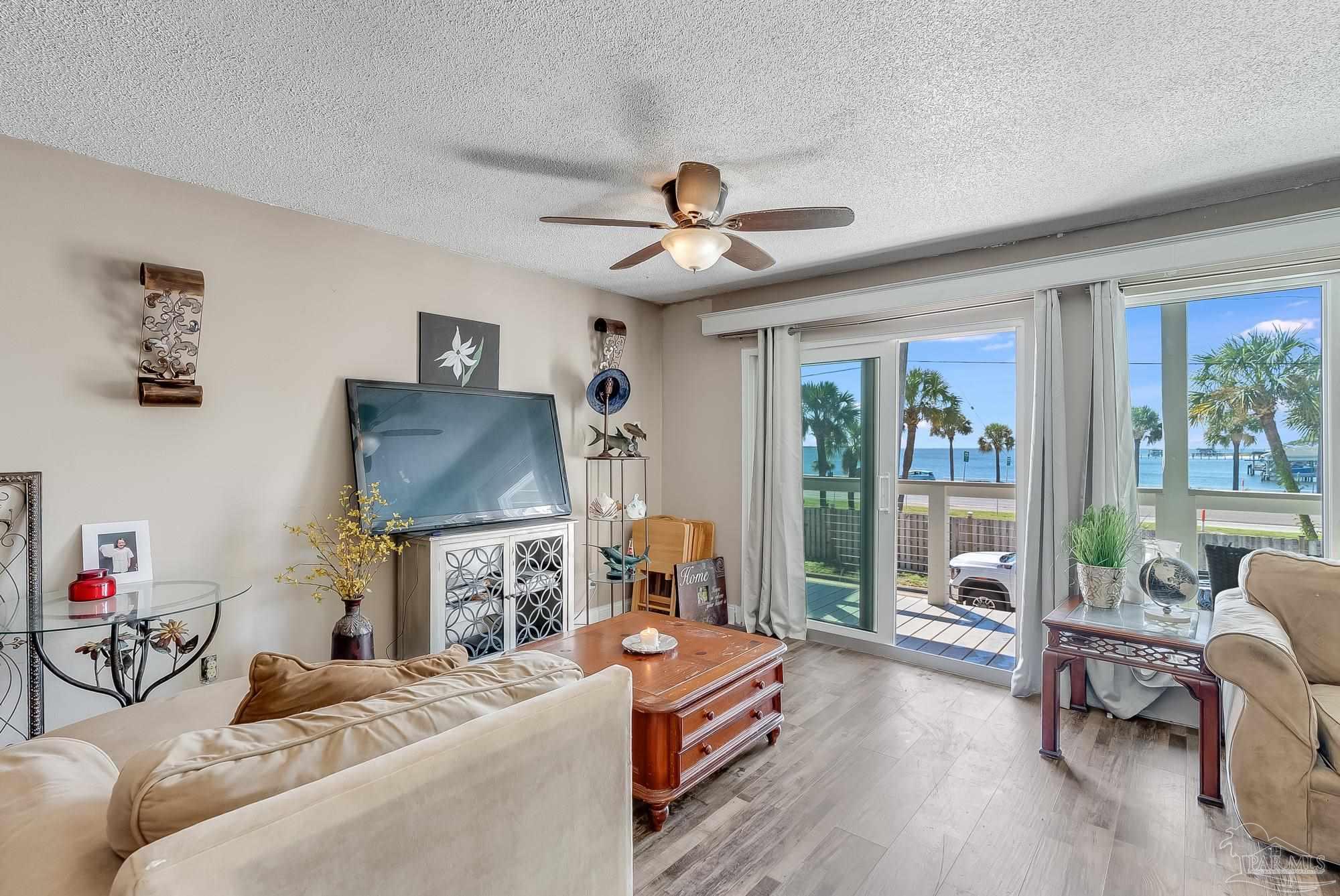 200 Pensacola Beach Road, Unit D2 Gulf Breeze, FL 32561 - Photo 7 of 40 a living room with furniture a flat screen tv and a large window