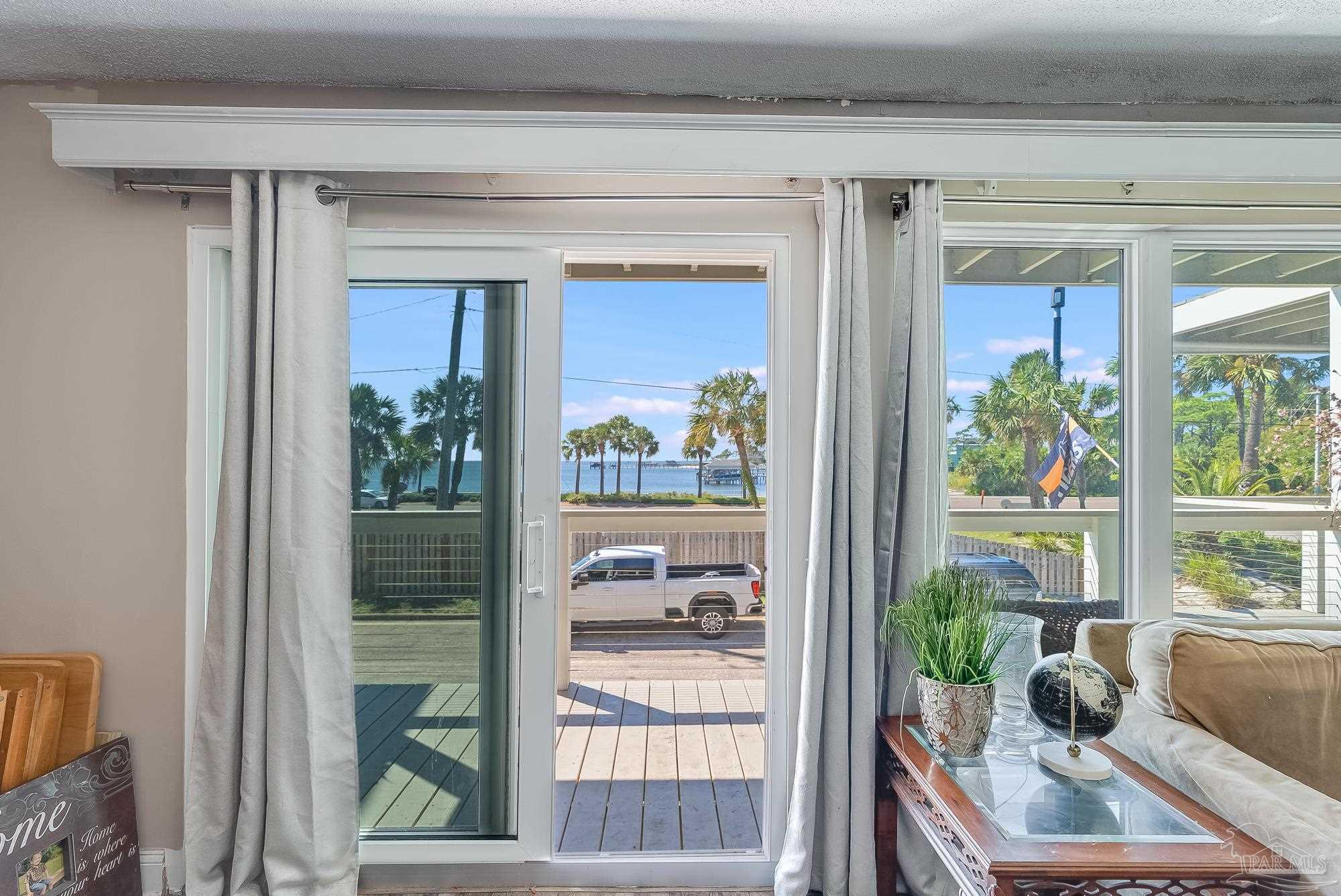 200 Pensacola Beach Road, Unit D2 Gulf Breeze, FL 32561 - Photo 8 of 40 a room with a couch and a potted plant