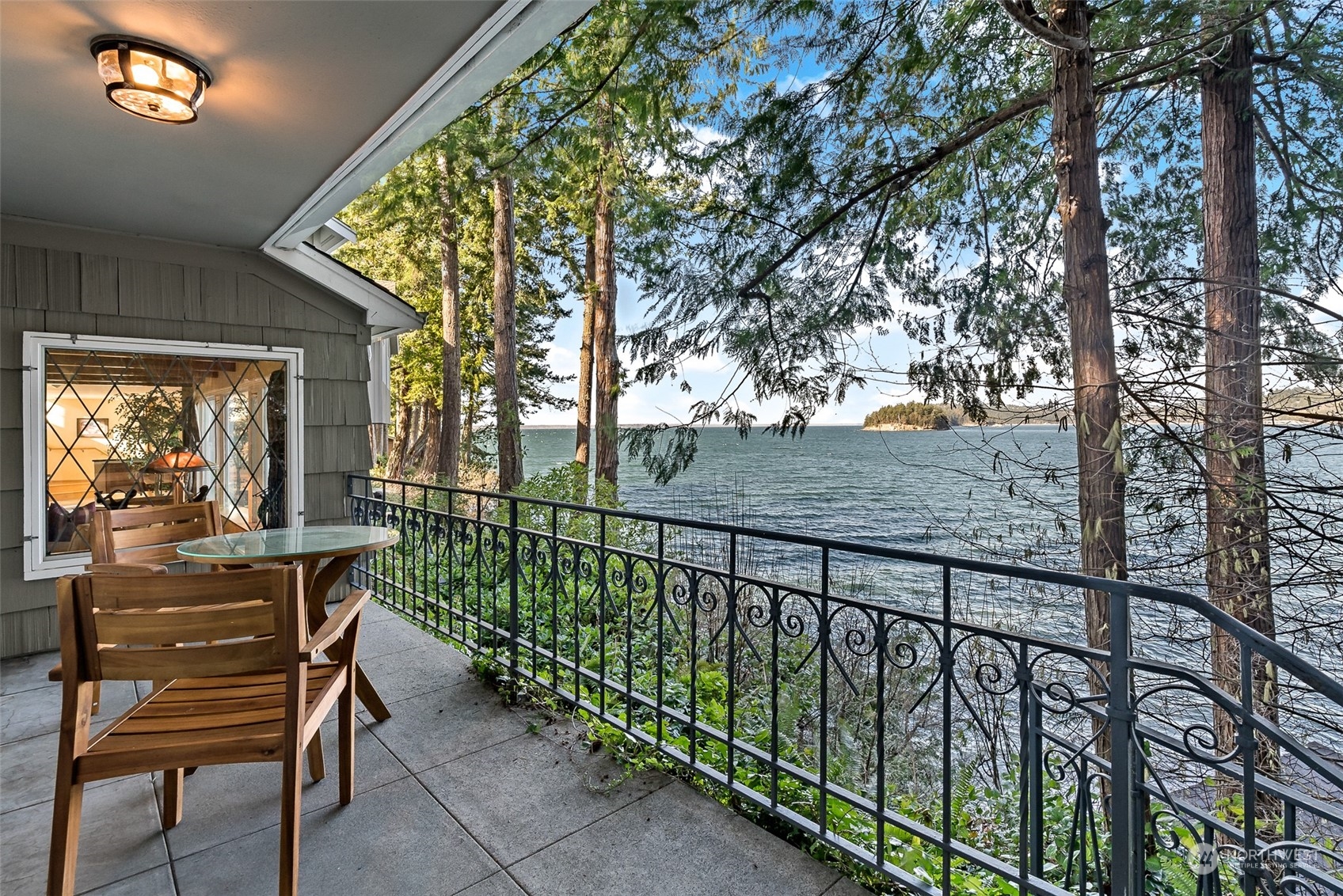 316 Chuckanut Point Road Bellingham, WA 98229 - Photo 23 of 40 a view of a balcony with chairs and wooden fence
