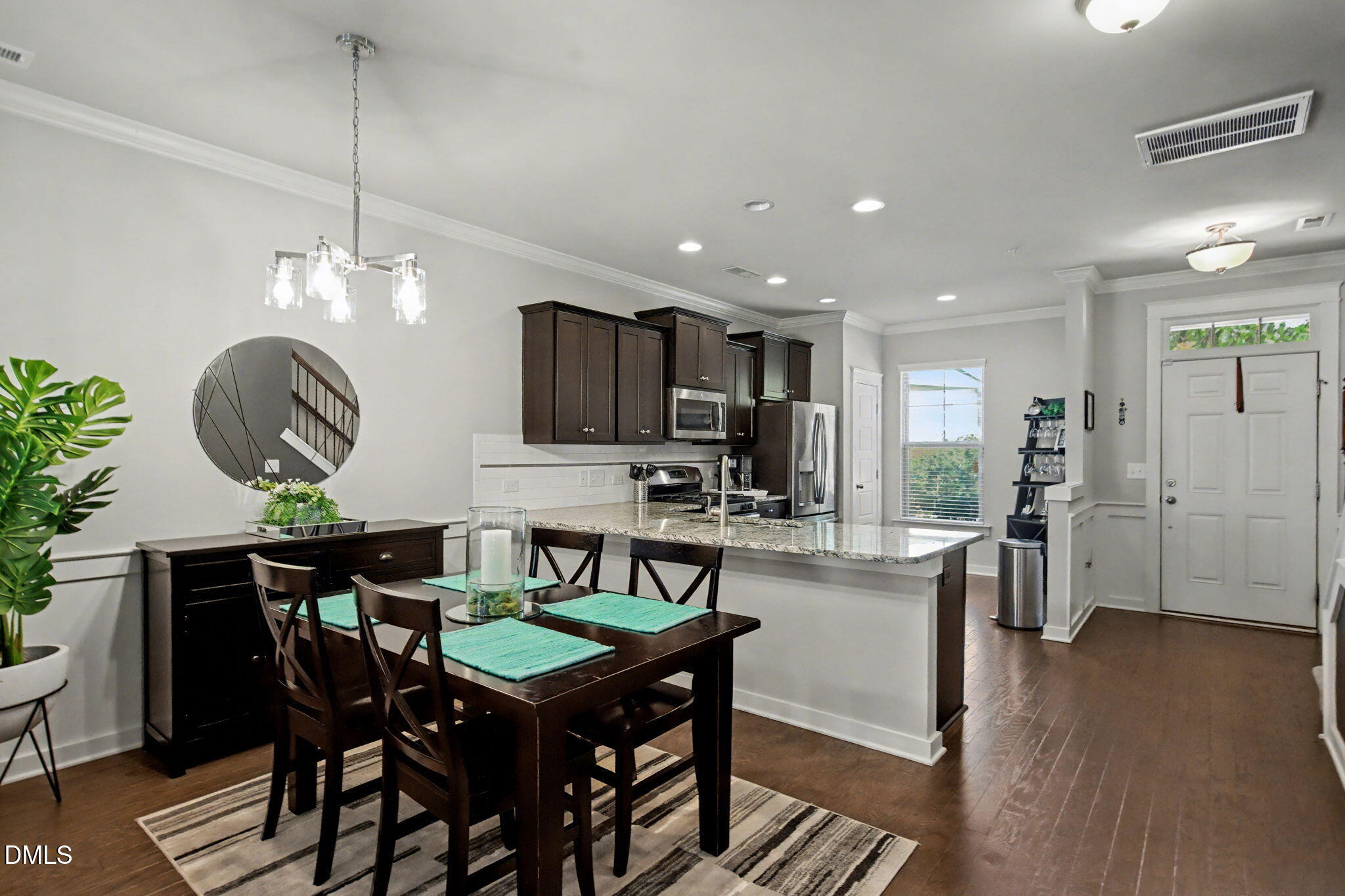 6321 Pesta Court Raleigh, NC 27612 - Photo 11 of 26 a view of a dining room with furniture a rug and wooden floor