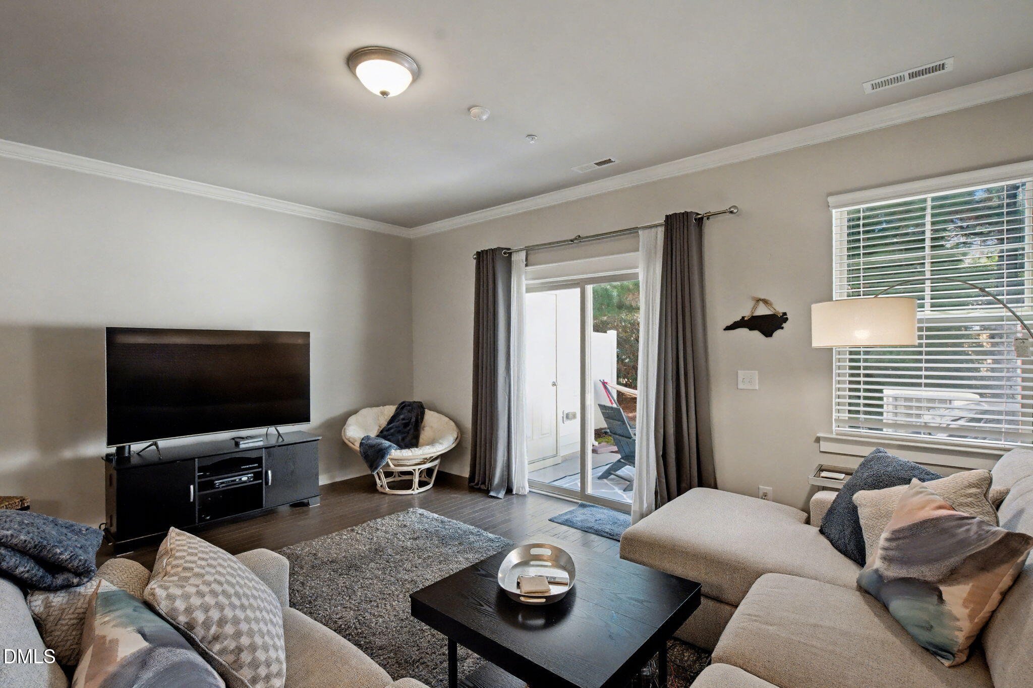 6321 Pesta Court Raleigh, NC 27612 - Photo 13 of 26 a living room with furniture and a flat screen tv