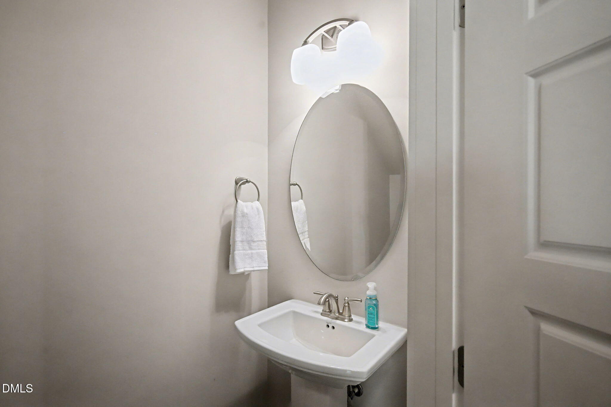 6321 Pesta Court Raleigh, NC 27612 - Photo 15 of 26 a bathroom with a sink and a mirror