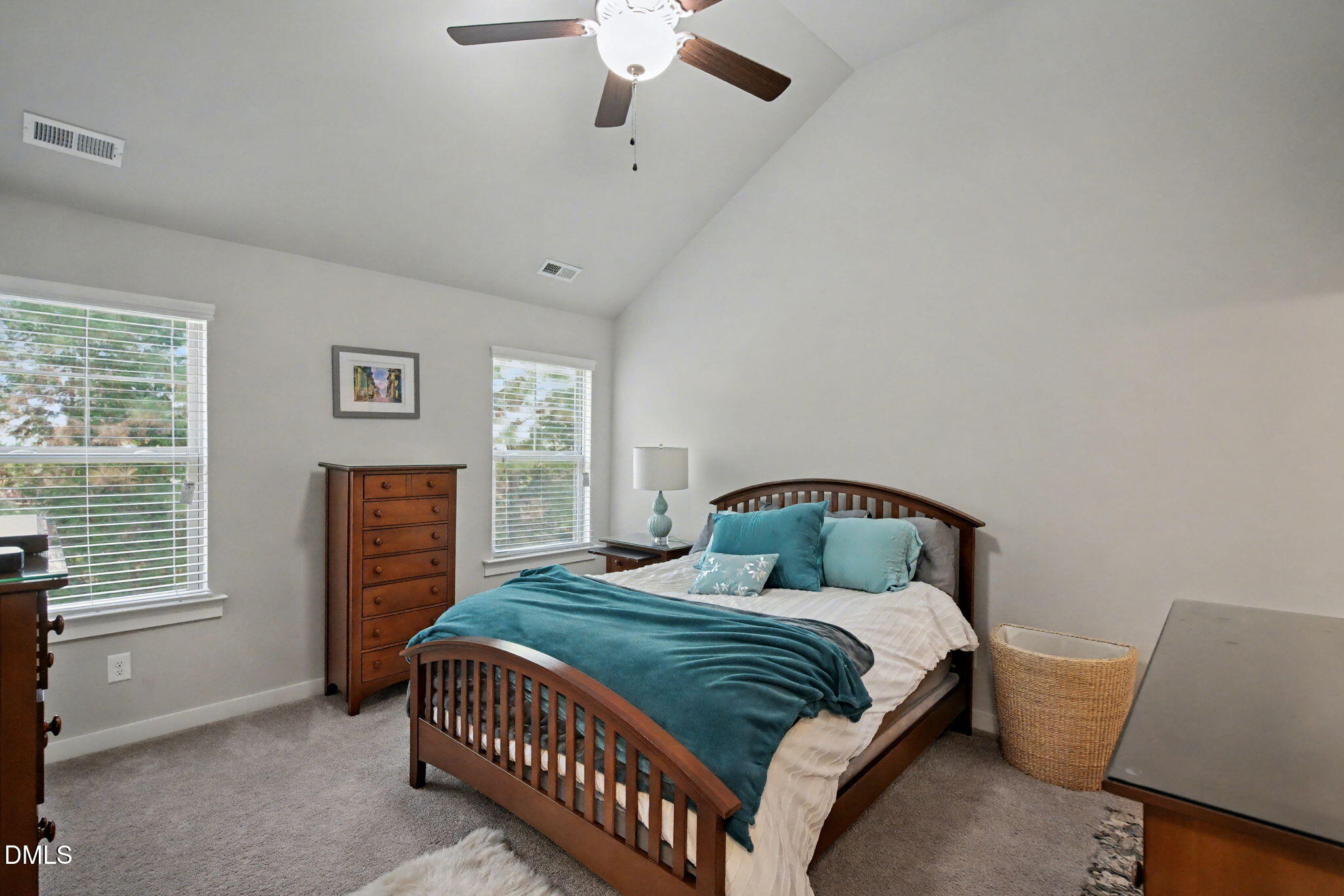 6321 Pesta Court Raleigh, NC 27612 - Photo 16 of 26 a bedroom with a bed and dresser with mirror