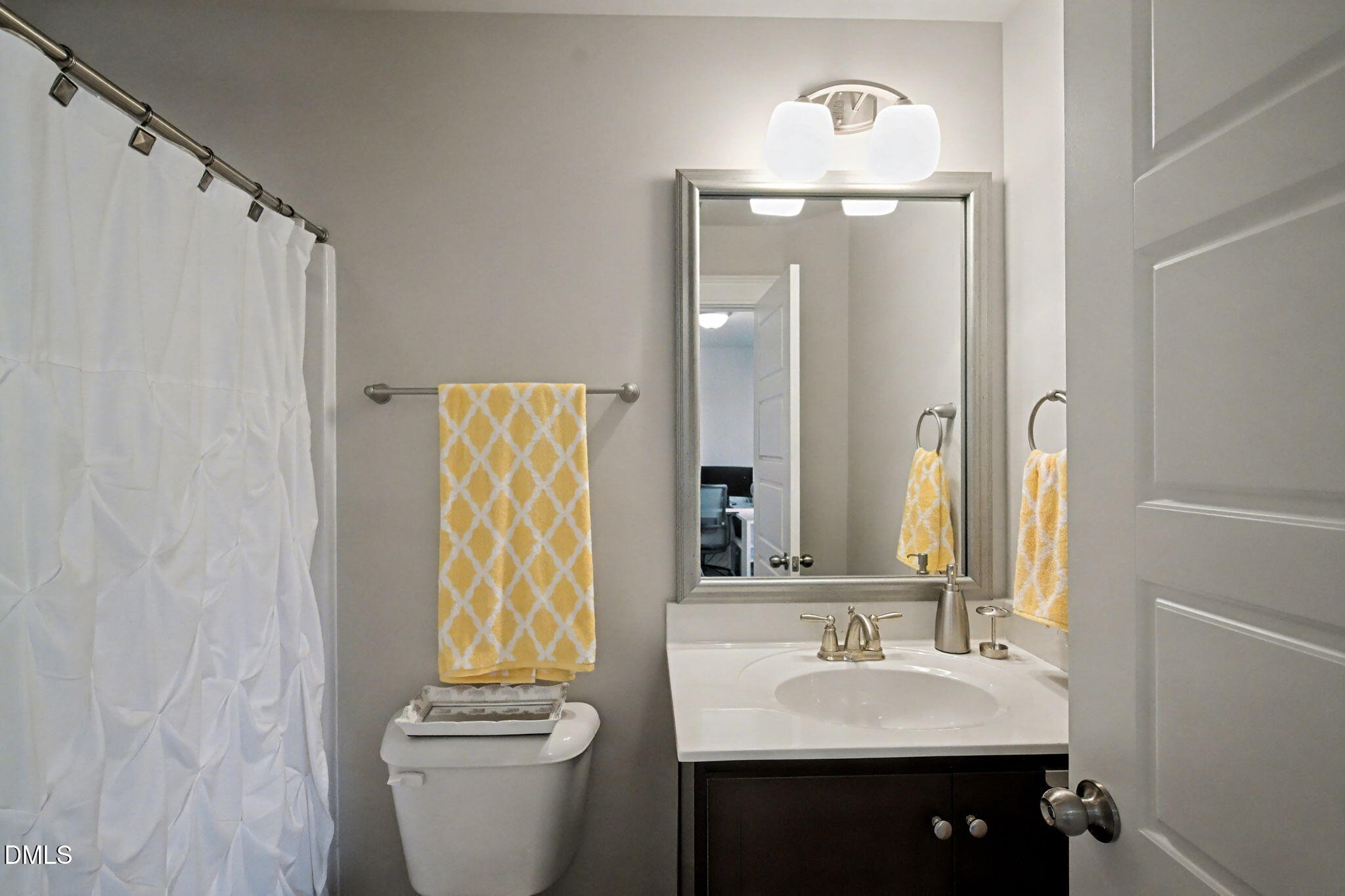 6321 Pesta Court Raleigh, NC 27612 - Photo 21 of 26 a bathroom with a sink a toilet and a mirror
