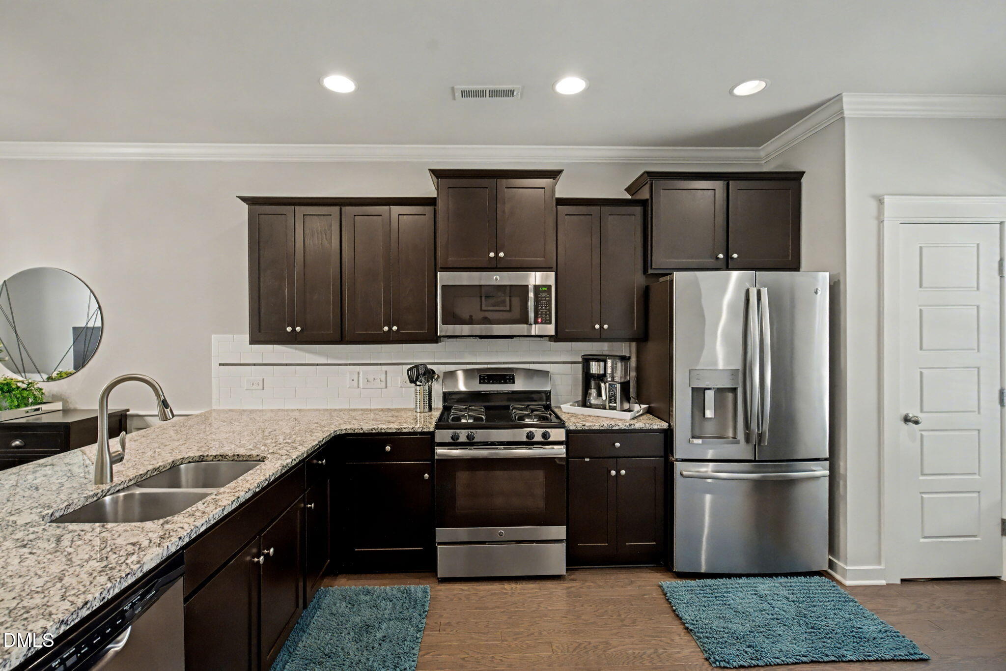6321 Pesta Court Raleigh, NC 27612 - Photo 7 of 26 a kitchen with granite countertop a refrigerator and a sink