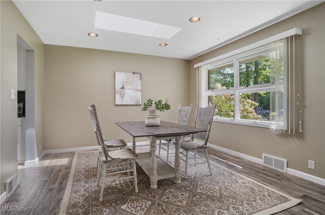 4555 Ranchwood Road Akron, OH 44333 - Photo 14 of 43 Dining area featuring a skylight, recessed lighting, and wood finished floors
