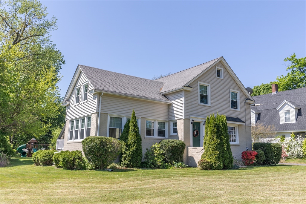 a front view of house with yard and green space