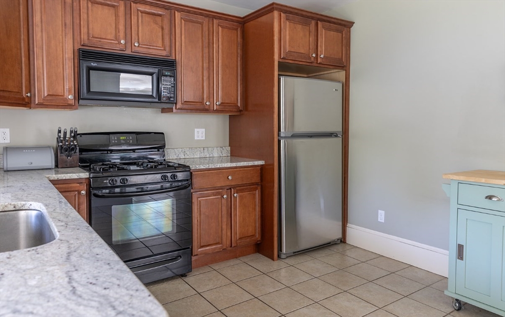 103 Maple Road Longmeadow, MA 01106 - Photo 22 of 35 a kitchen with granite countertop a stove and a microwave