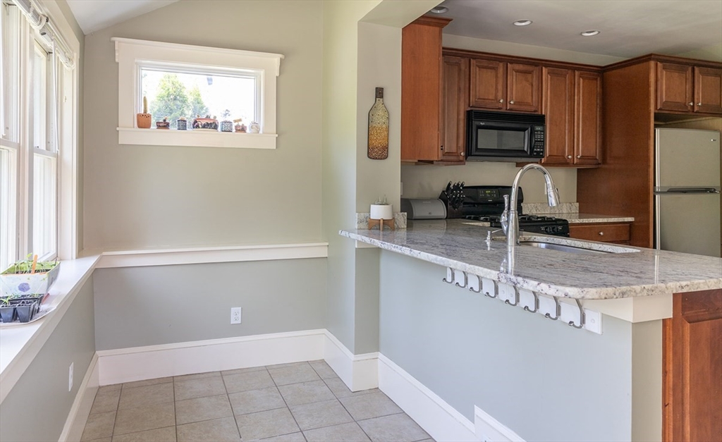 103 Maple Road Longmeadow, MA 01106 - Photo 23 of 35 a kitchen with granite countertop a stove a sink and a microwave