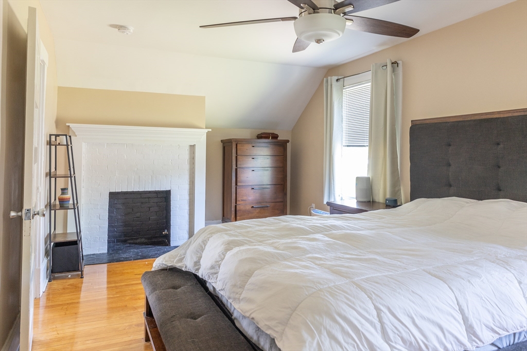 103 Maple Road Longmeadow, MA 01106 - Photo 28 of 35 a bedroom with a bed and a fireplace