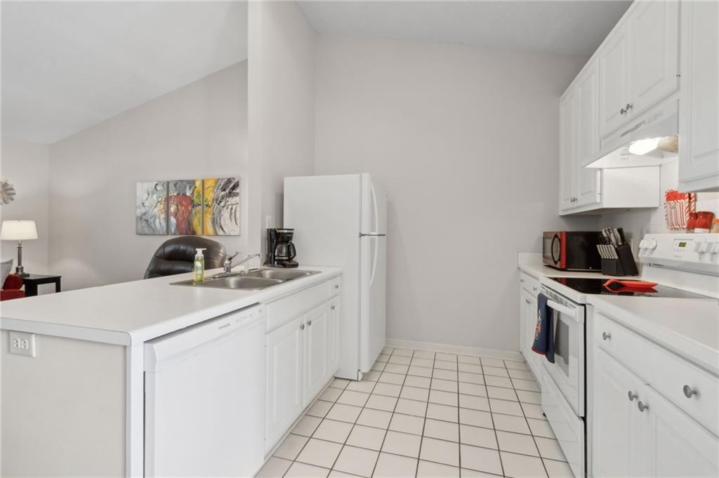 2905 Florence Drive Gainesville, GA 30504 - Photo 15 of 32 a kitchen with a sink a stove and a refrigerator