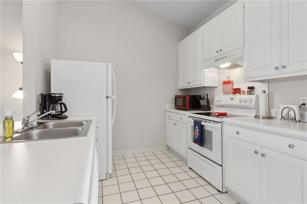 2905 Florence Drive Gainesville, GA 30504 - Photo 16 of 32 a kitchen with a sink stove and white cabinets