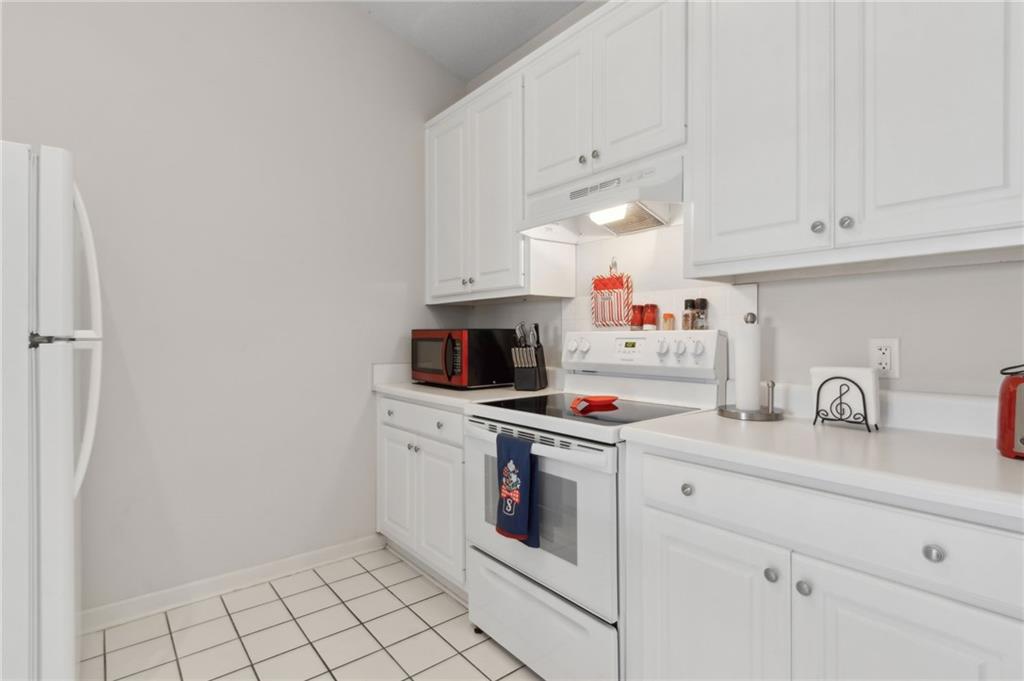 2905 Florence Drive Gainesville, GA 30504 - Photo 17 of 32 a kitchen with white cabinets and white appliances