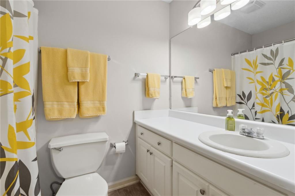2905 Florence Drive Gainesville, GA 30504 - Photo 23 of 32 a bathroom with a granite countertop toilet sink and mirror