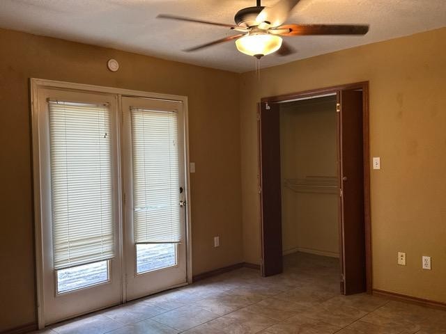 408 Ruth Street Kerrville, TX 78028 - Photo 7 of 12 an empty room with windows and fan