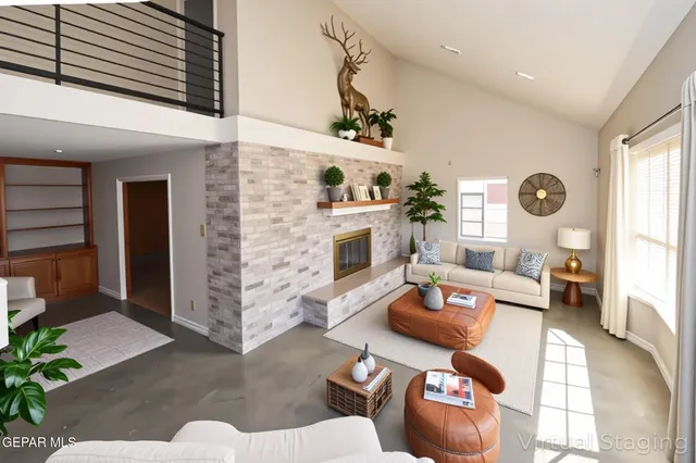 a view of empty room with windows and fireplace