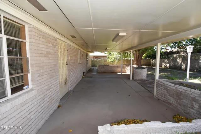 a bedroom with a bed a couch and a window