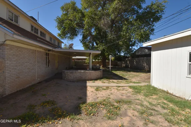 a spacious bedroom with a bed and a chandelier