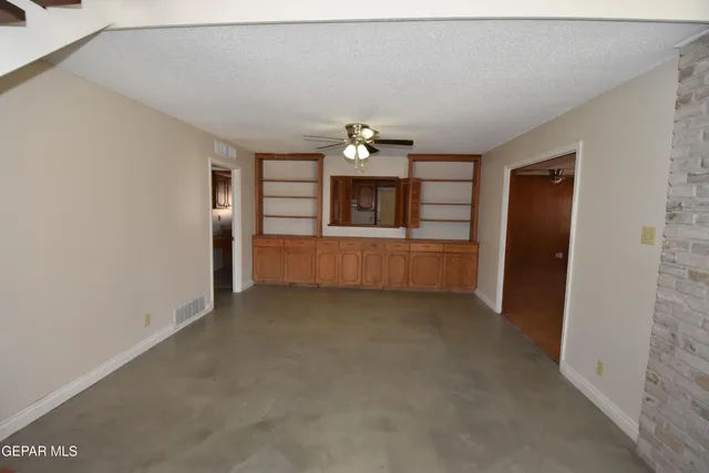 an empty room with windows and closet