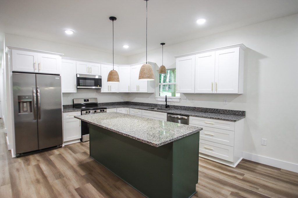 329 Webb Drive Sparta, TN 38583 - Photo 8 of 17 a kitchen with kitchen island granite countertop a sink a counter top space stainless steel appliances and cabinets