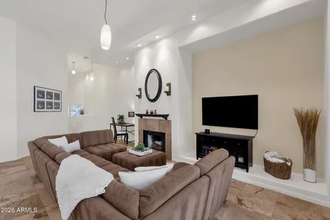 a living room with furniture a fireplace and a flat screen tv