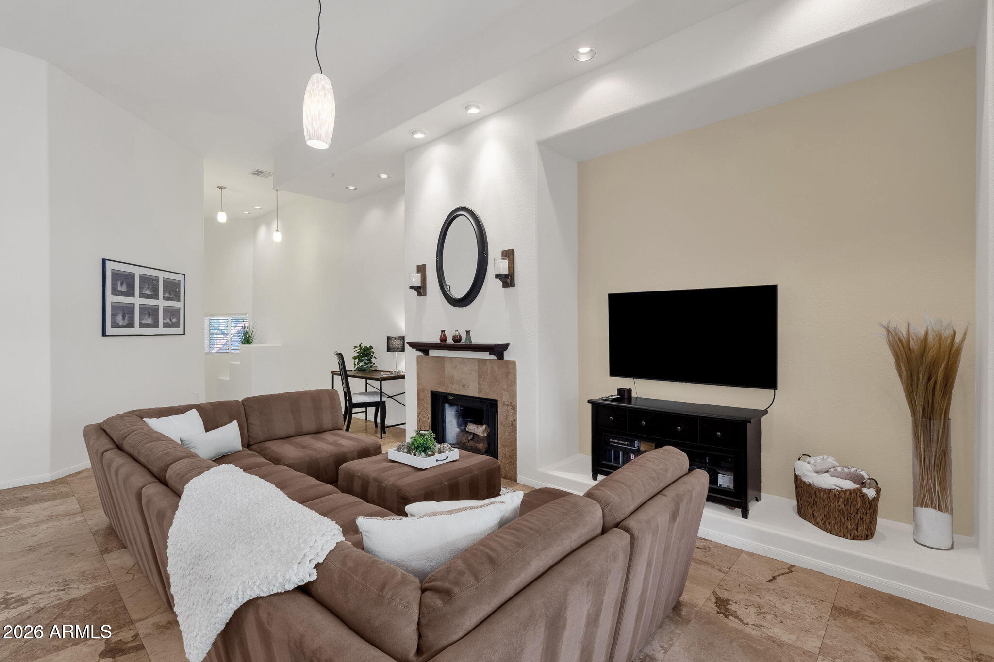8245 East Bell Road, Unit 208 Scottsdale, AZ 85260 - Photo 22 of 48 a living room with furniture a fireplace and a flat screen tv