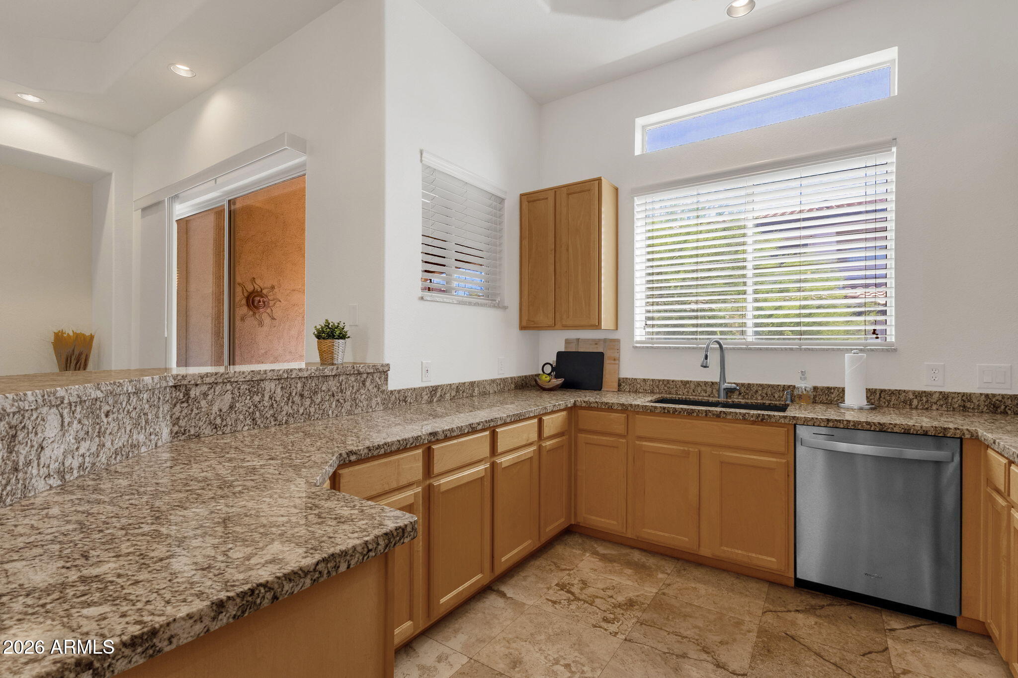 8245 East Bell Road, Unit 208 Scottsdale, AZ 85260 - Photo 26 of 48 a kitchen with stainless steel appliances granite countertop a sink stove and granite counter tops